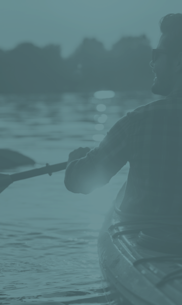 Man paddling a boat on a lake