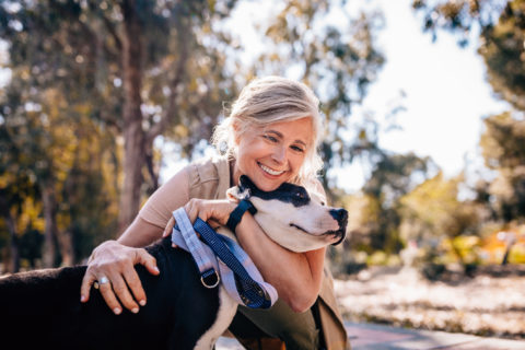 Woman embracing her dog in the park