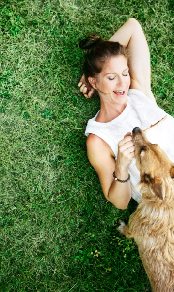 Full-color Woman playing with dog in park