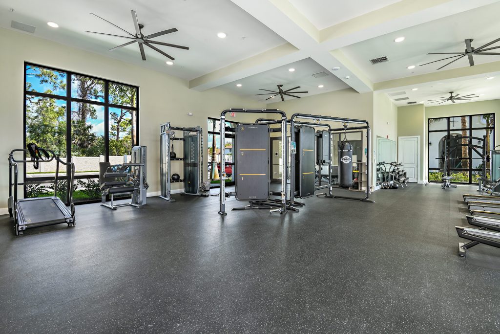 Indoor gym area with workout machines, punching bags, and medicine balls