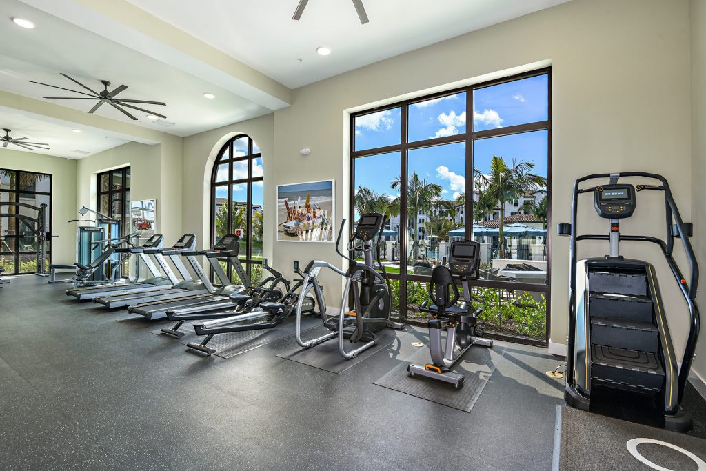 Indoor gym area with workout machines and floor to ceiling windows