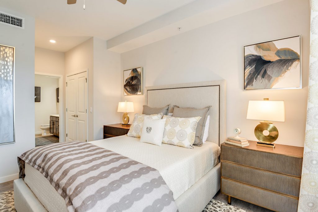 Bedroom area with outdoor lighting, wall paintings, and modern decor