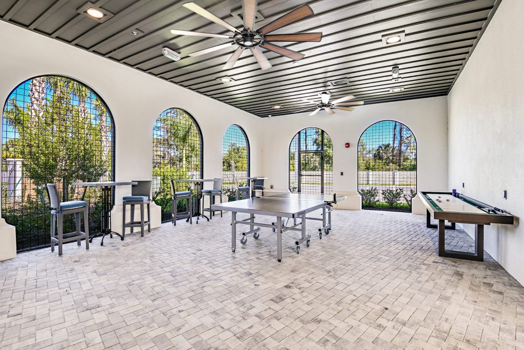 Outdoor covered seating area with ping pong table and shuffleboard