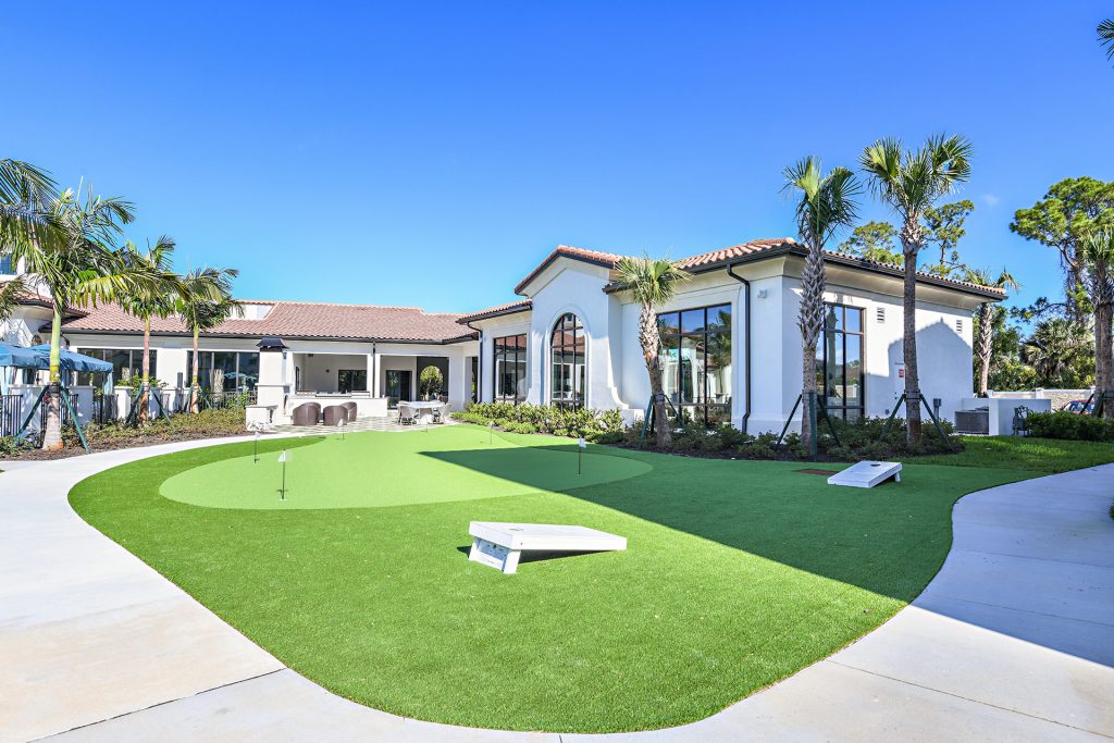 Outside playing area with putting green and cornhole boards