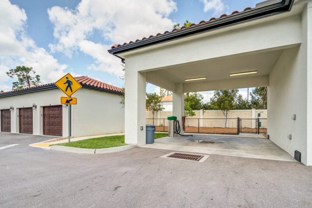 Outdoor exterior with covered wash area, crosswalk, and garage storage